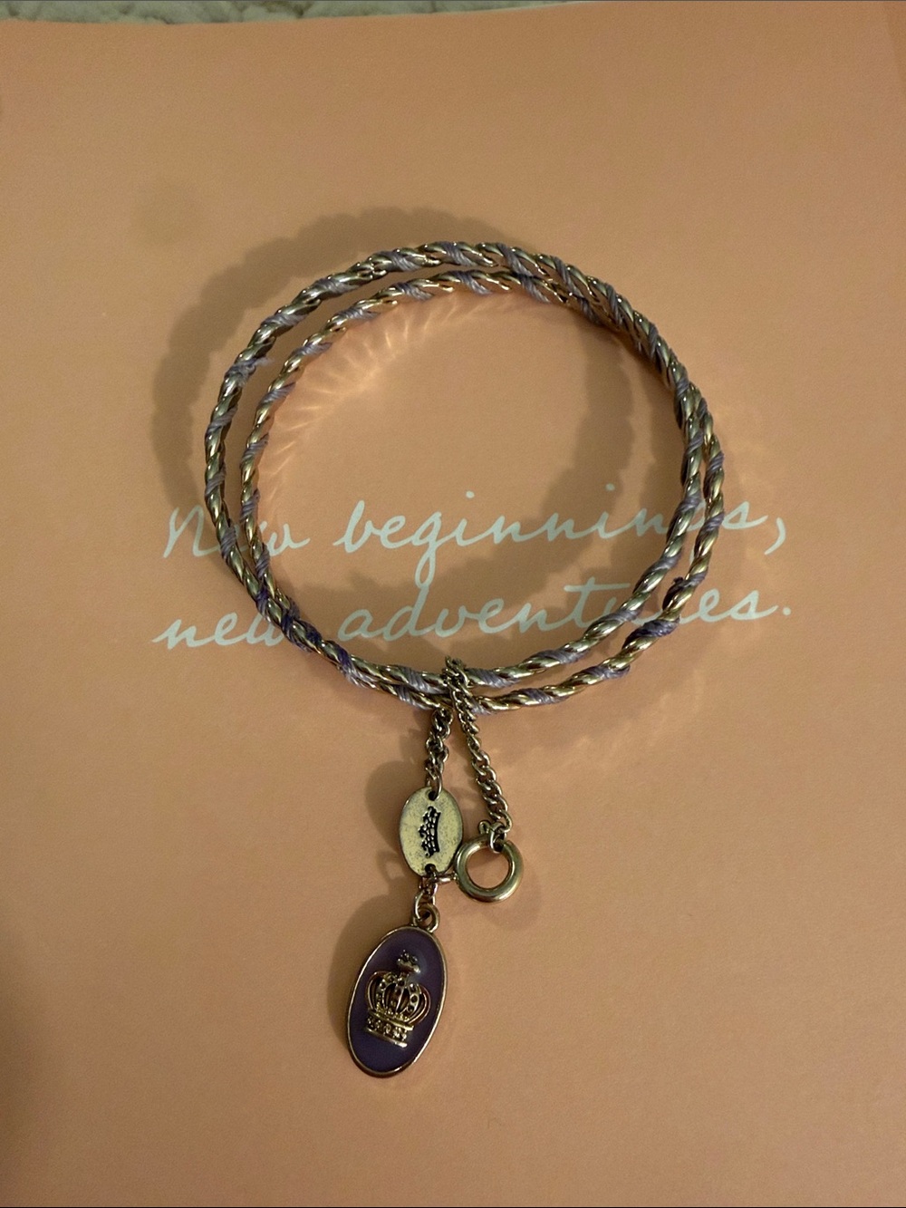 Juicy Couture Gold-Tone Twisted Bangle with Purple Crown Charm